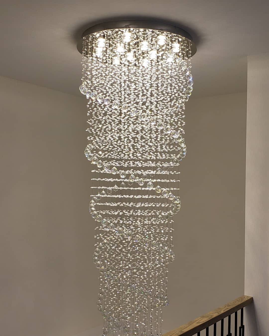 Crystal cascade chandelier installed above a stairwell